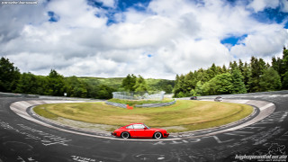 Red car curvy road trees - wide angle len free wallpaper