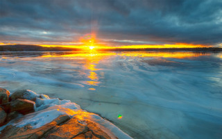 Sunset frozen lake rocks ice - a sunset over a free wallpaper
