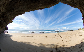 Beach cave view sunny day - a cave free wallpaper