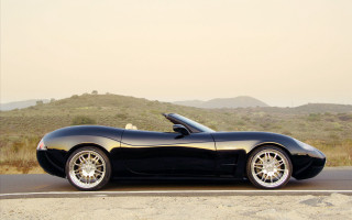 Black sports car mountain road 2 - a black sports car free wallpaper