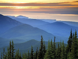 Mountain range trees sunset clouds - a view of a mountain range free wallpaper