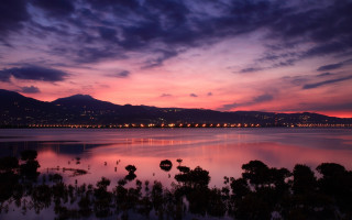 Sunset lake mountains city lights - a beautiful sunset over a lake free wallpaper