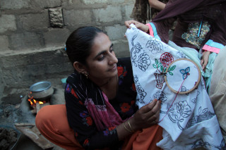 Woman holding cloth cross candle - feminist free wallpaper