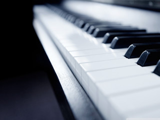 Piano keyboard closeup black background - cinematic composition free wallpaper