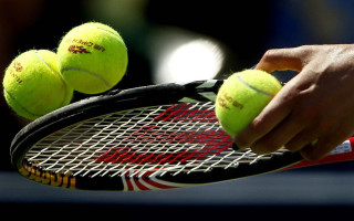 Tennis person holding racket balls - free sports wallpaper