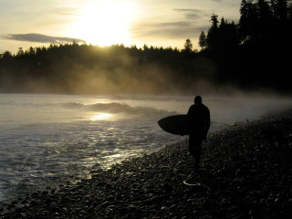 Man holding surfboard beach sunset - mist free wallpaper for desktop