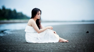 Woman white dress sitting beach - chen jiru free wallpaper