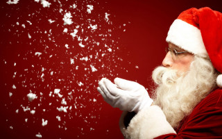 Santa claus blowing snowflakes hands - free christmas wallpaper for desktop