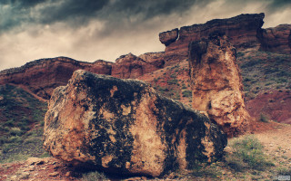 Giant rock mountain scene bird - under a cloudy sky free wallpaper