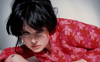 Woman blackhair redshirt bed portrait - black hair free wallpaper