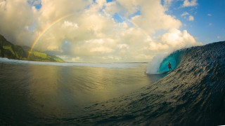 Person riding wave surfboard rainbow 2 - evan charlton free wallpaper
