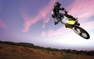 Man motorcycle air trick yellow - motion blur free wallpaper
