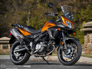 Motorcycle parked road stone wall - a bench in the foreground free wallpaper