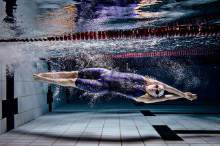 Man diving pool swimming suit - dynamic camera angle free wallpaper