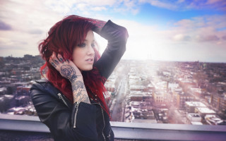 Woman red hair tattoos arm - a cityscape free wallpaper