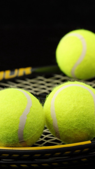 Tennis balls racket black background - free sports wallpaper