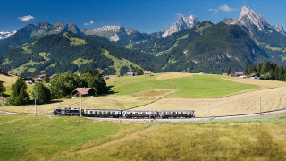 Train countryside mountains trees sunny - a train traveling free wallpaper