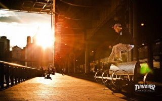 Man skateboarding rail city sunset - the sun shining free wallpaper