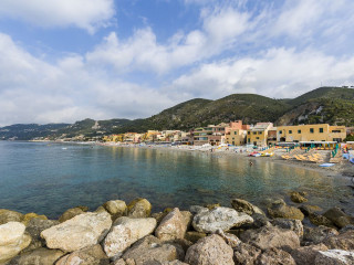 Beach rocks buildings people water - cagnaccio di san pietro free wallpaper