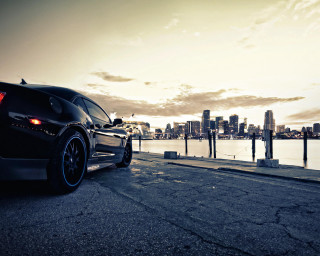 Black car road water city - a black car free wallpaper