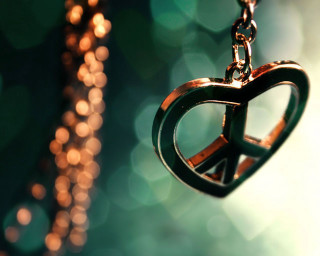 Peace sign necklace blurry background - a chain free wallpaper