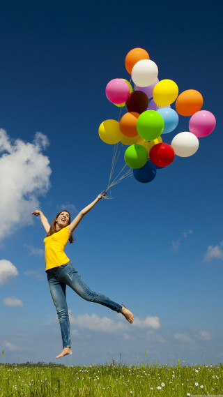 Woman yellow shirt holding balloons - free happy birthday wallpaper for mobile