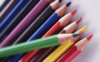 Colored pencils lined up white - a white background behind them free wallpaper