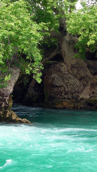 Man kayaking river rock formation - free nature wallpaper for mobile