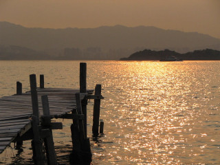 Dock boat water mountains distance - a dock free wallpaper