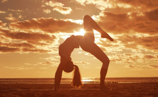 Woman handstand beach sunset sun - symmetric free wallpaper