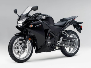 Black motorcycle parked white gray - a gray background behind free wallpaper