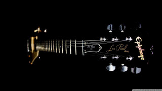 Guitar closeup black background gold - eric de kolb free wallpaper