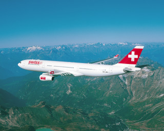 Swiss airplane flying mountain range - over a mountain range in the sky free wallpaper
