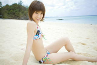 Woman bikini beach smile legs - a blue sky and ocean in the background free wallpaper