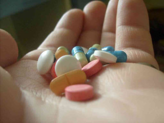 Person holding pills single pill - raw free wallpaper
