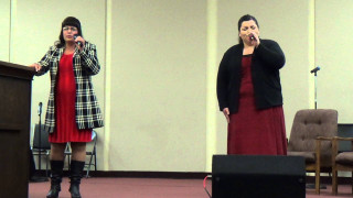 Woman standing podium microphone another - her hand and another woman free wallpaper