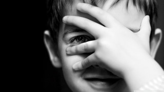 Young boy hands face eyes - his finger free wallpaper