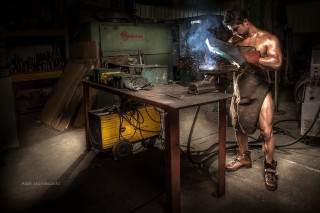 Man working metal workshop welding - photography free wallpaper