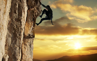 Man climbing cliff sunset backpack - extreme free wallpaper