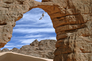Man climbing rock rope desert - a rock formation free wallpaper