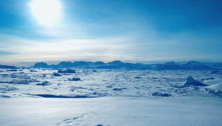 Snowy mountains sun sky lake - a bright sun in the sky above free wallpaper