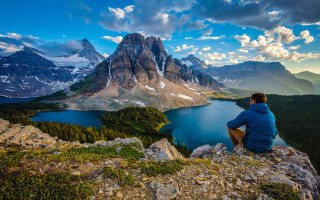Man sitting rock mountain lake - bob ross free wallpaper