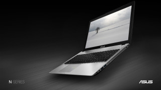 Laptop wooden table dark room - a laptop computer free wallpaper