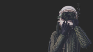 Green jacket gloves covering face - solarpunk free wallpaper