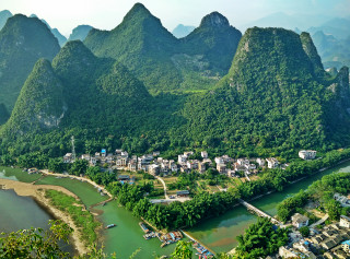 Small village surrounded by mountains - a town free wallpaper