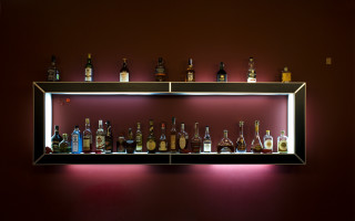 Shelf liquor bottles red wall - diffuse lighting free wallpaper for desktop