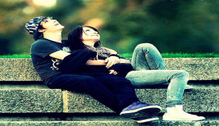 Romantic man woman smiling outdoors - a stone wall free wallpaper