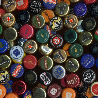 Colorful bottle caps black background - a tilt shift photo free wallpaper for tablet