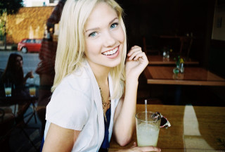 Woman sitting table drink glass - a drink in front free wallpaper