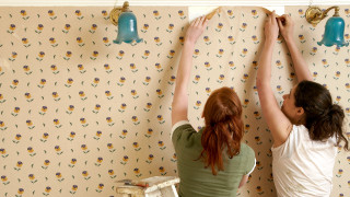 Women fixing wallpaper blue lights - a flower pattern free wallpaper